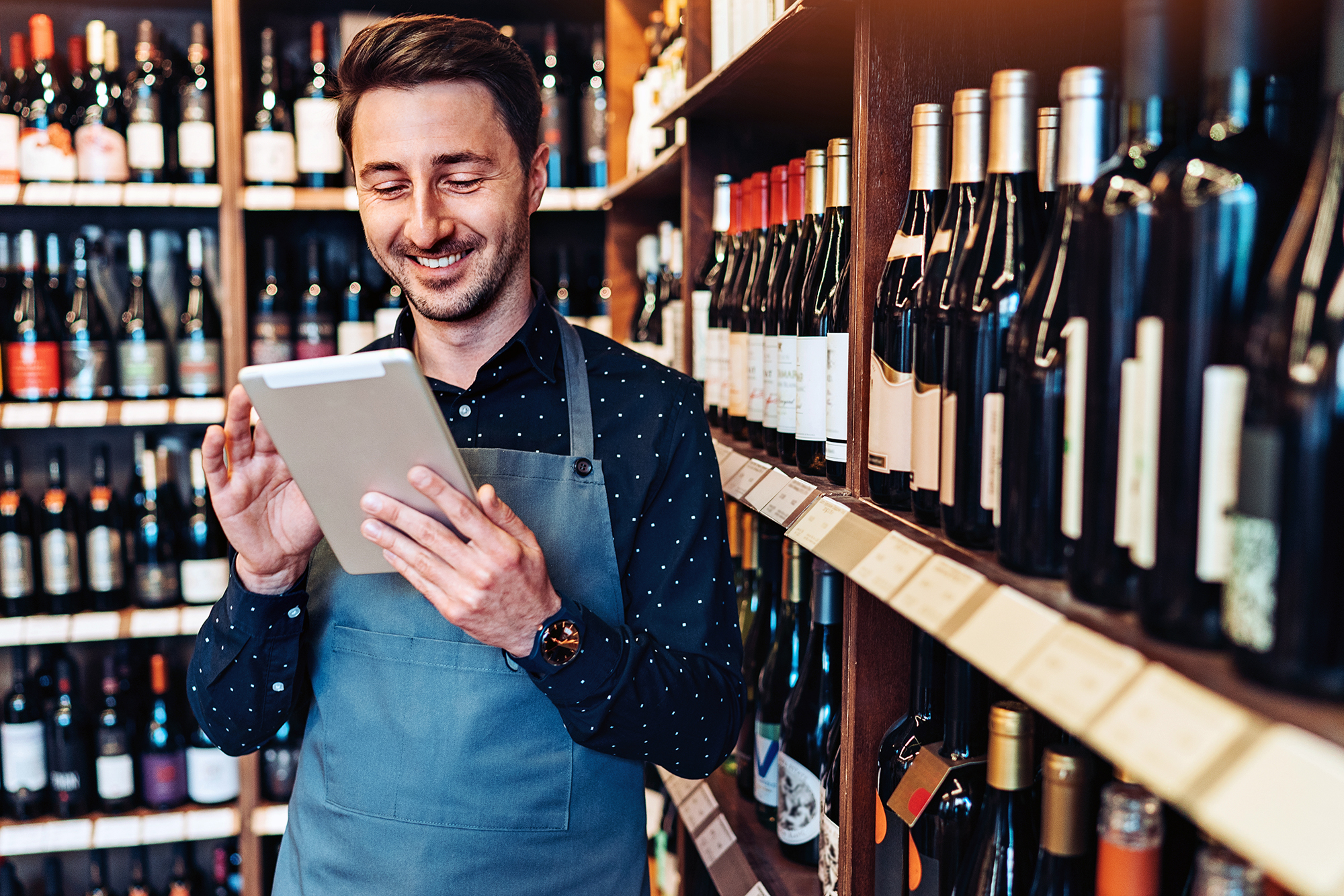 Bottle store employee on tablet