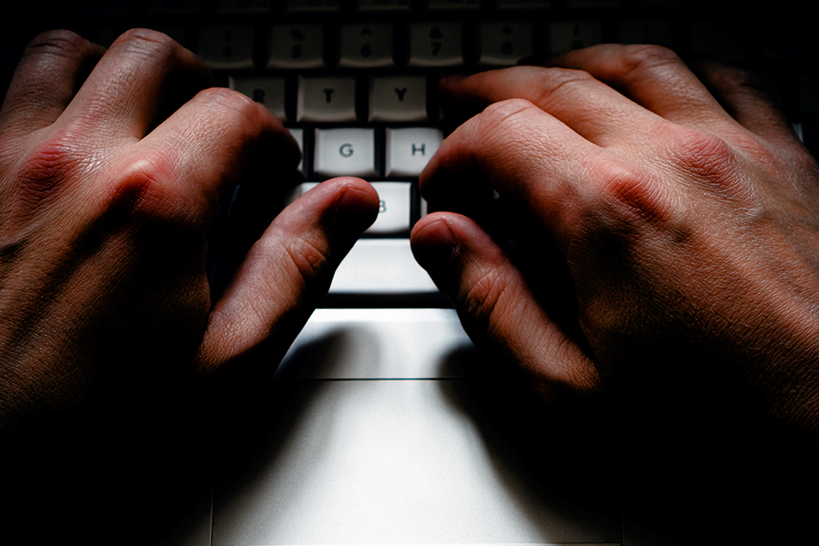 Moody hands on computer keyboard