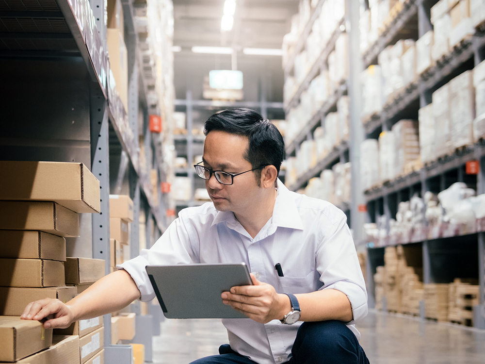 Man using digital tablet looking at inventory