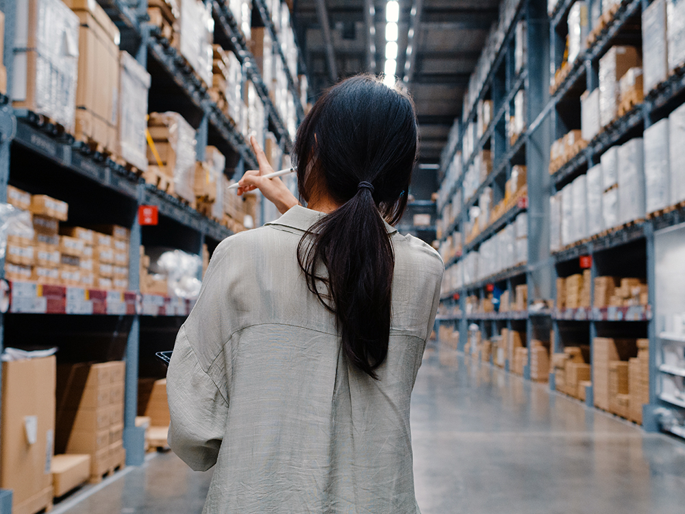 Woman using digital tablet looking at inventory